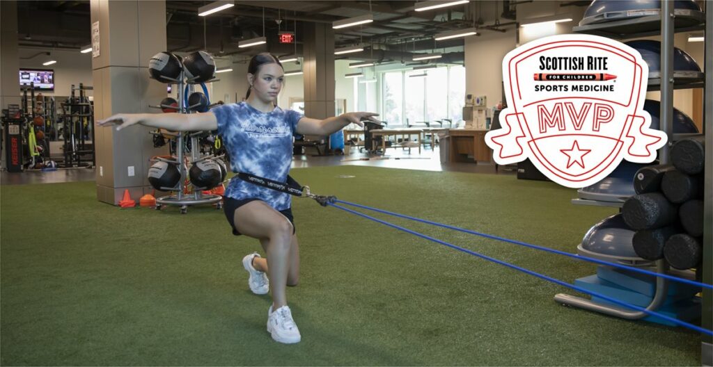 A woman in a gym with a scottish rite logo in the background | KEISER AMAX EXIT Aeropostale NEW YORK AMAX 12 ДУПАТ IN VENTIMAX VERTIMAX VENTIM SCOTTISH RITE FOR CHILDREN SPORTS MEDICINE MVP 080 D