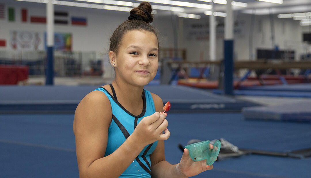 Young girl in gymnastics gym.