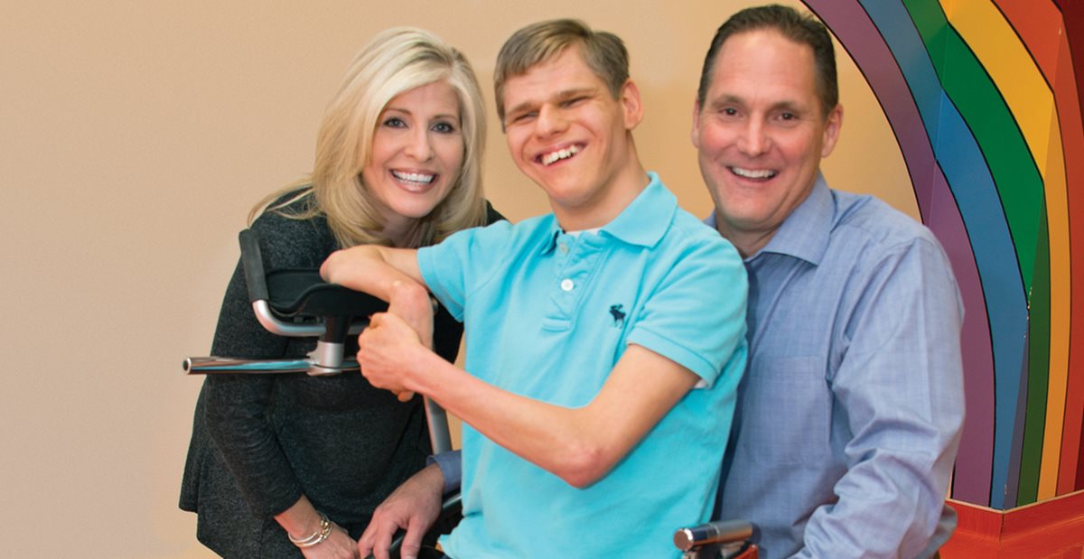 JohnMichael, a patient at Texas Scottish Rite Hospital for Children, with hospital personnel