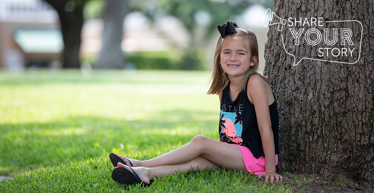 girl outside under a tree