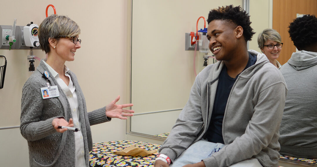 Dr. Richard works with a patient in clinic.