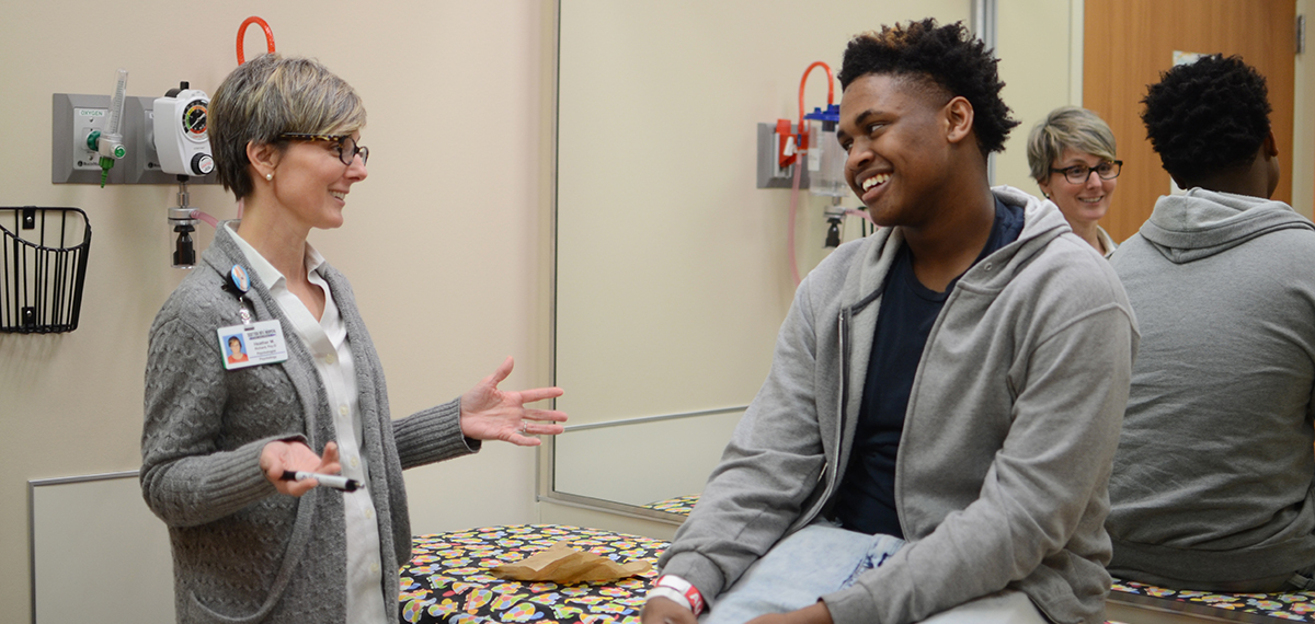 Dr. Richard works with a patient in clinic.