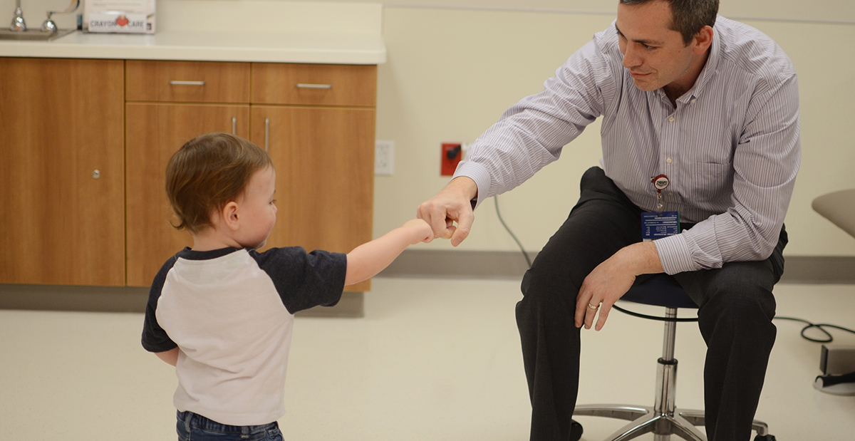 Dr. Gill with a patient in clinic