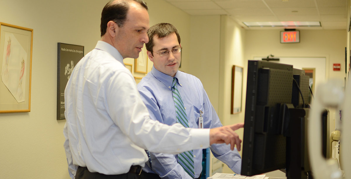 Dr Sucato and Dr Gill look at a computer together