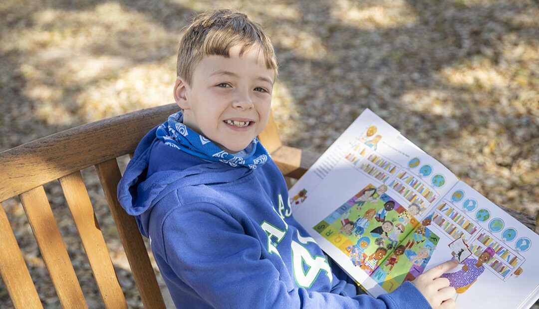 Miles on park bench with book