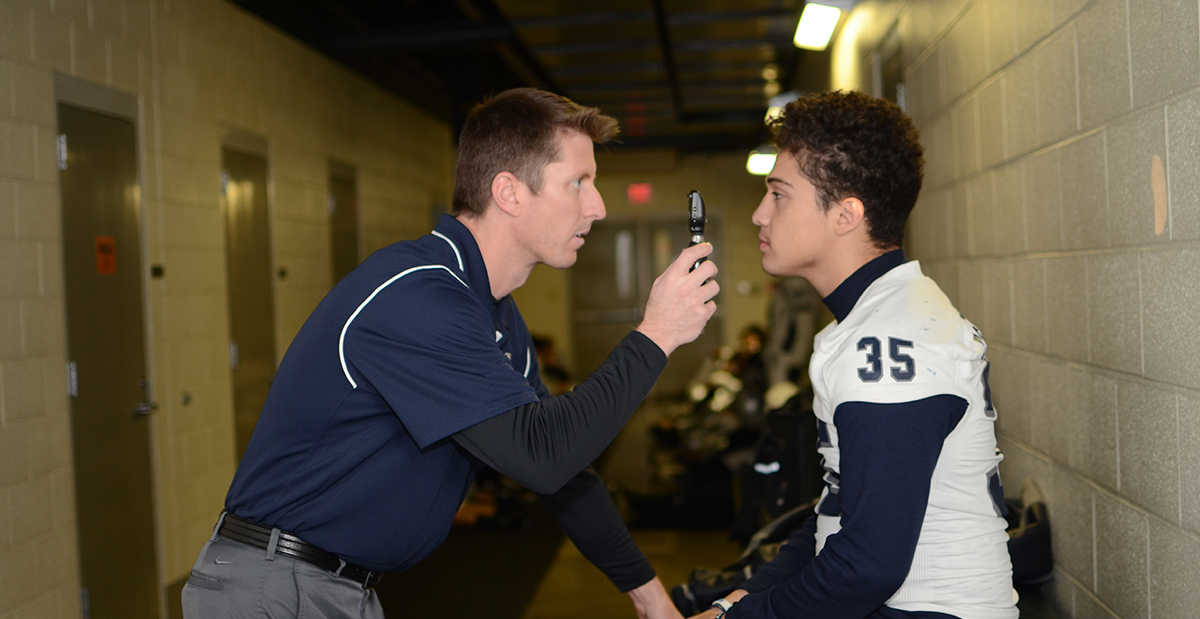 Miller in football tunnel doing head exam